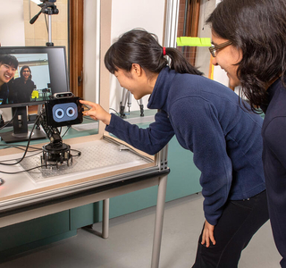 Faculty members working on computer